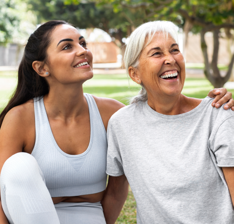 young woman and adult woman smiling