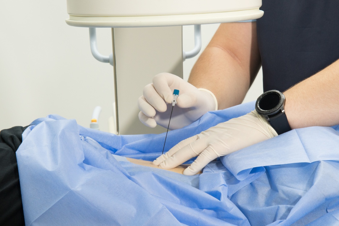 A medical professional gives an injection into the patient's arm . Hands of a medical worker and a syringe close-up. needle, inject medicine