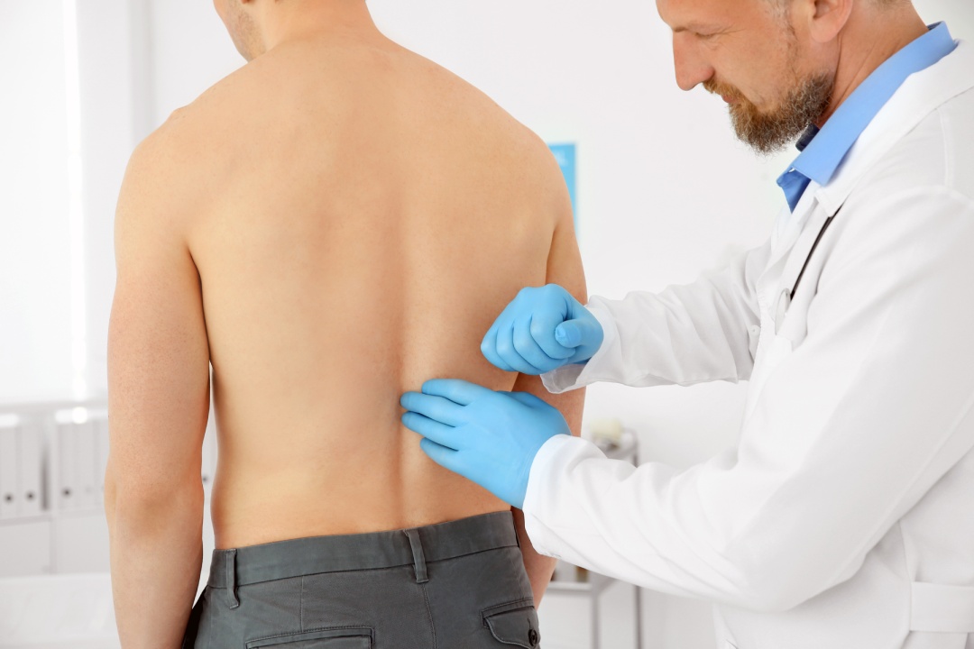 Urologist examining patient in hospital