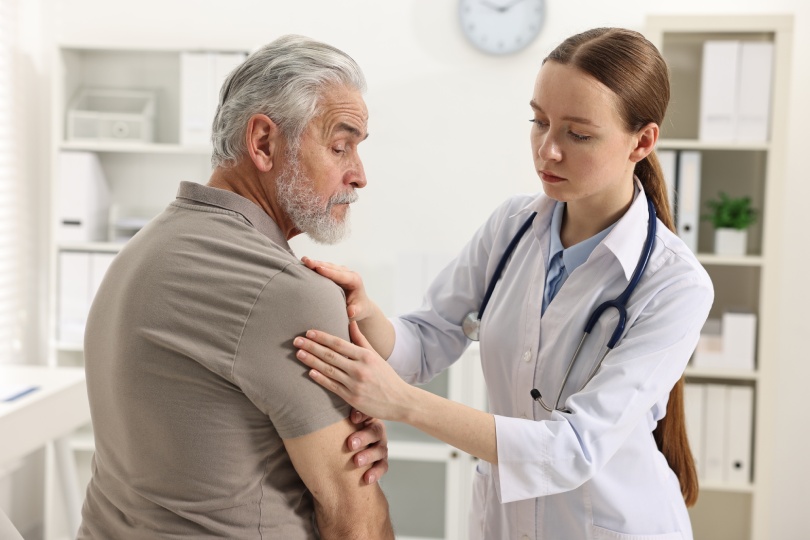 Arthritis symptoms. Doctor examining patient with shoulder pain in hospital