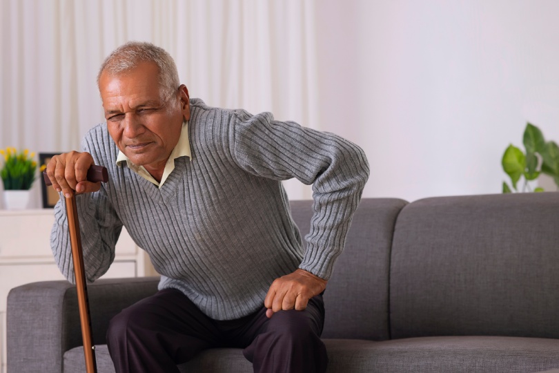 Senior man trying to stand alone with the help of walking stick